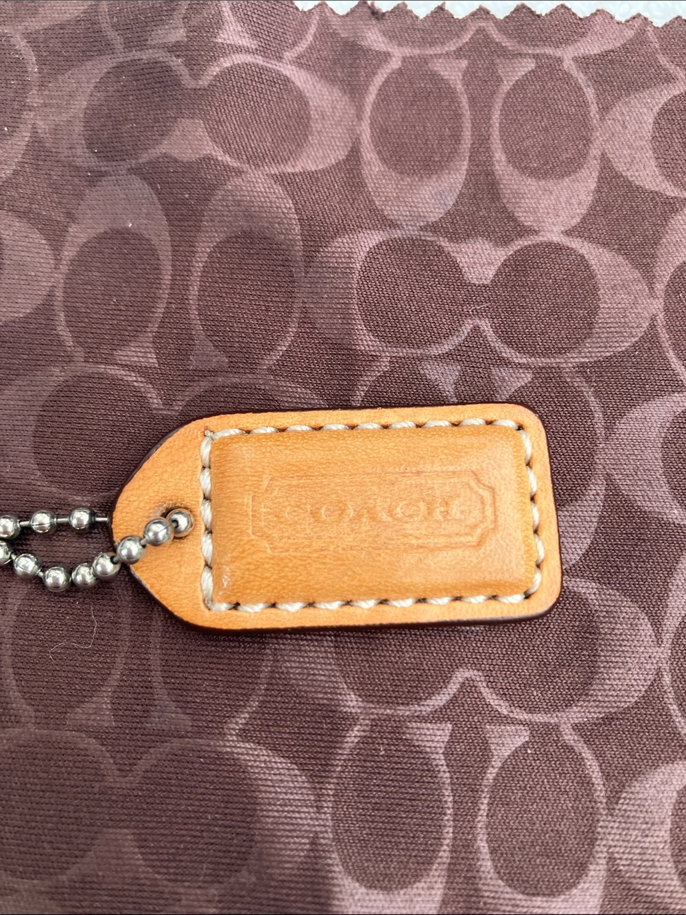 Coach small 1” tan leather hang tag with white stitching